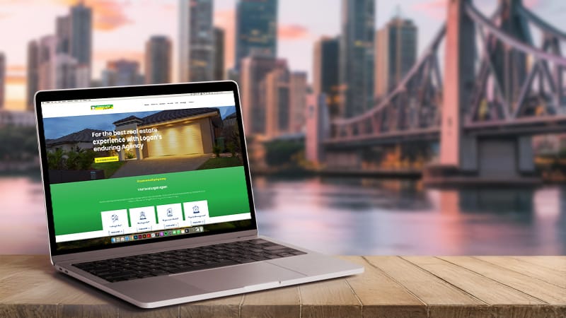 Laptop displaying website design with Brisbane city skyline in background